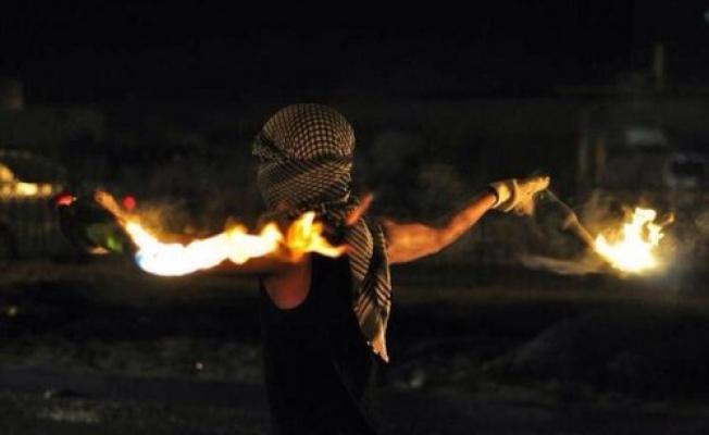 شاب فلسطيني يلقي المولوتوف على العدو