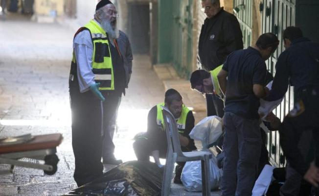 أعضاء فريق أمني إسرائيلي ينقلون جثة شهيد فلسطيني قُتل بعد طعنه شرطيا بالقدس القديمة